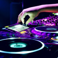 Dj mixes the track in the nightclub at a party
